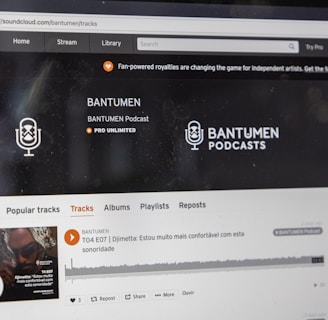 A computer screen displaying a website of an audio streaming service. The website showcases a podcast called BANTUMEN with the description 'Pro Unlimited.' There is a navigation bar with options including Home, Stream, Library, and more. A music wave graphic is visible below, along with a play button, social media interaction options such as re-post, share, and add to playlists. A banner at the top talks about fan-powered royalties, and there is a COVID-19 information widget to the side.